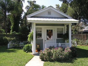 A playhouse, enhanced by appropriate plantings, makes a charming focal point for this backyard in Plant City. Photo by Monica Brandies