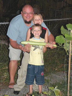 Son in law and grandsons Tony, Mike and David love to grow and eat cucuzzi.  Photo by Monica Brandies