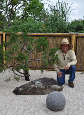 Crippen poses beside his prized southern red cedar. Photo by Tom Hewitt